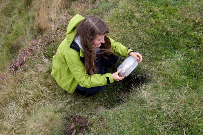 Young woman geocaching