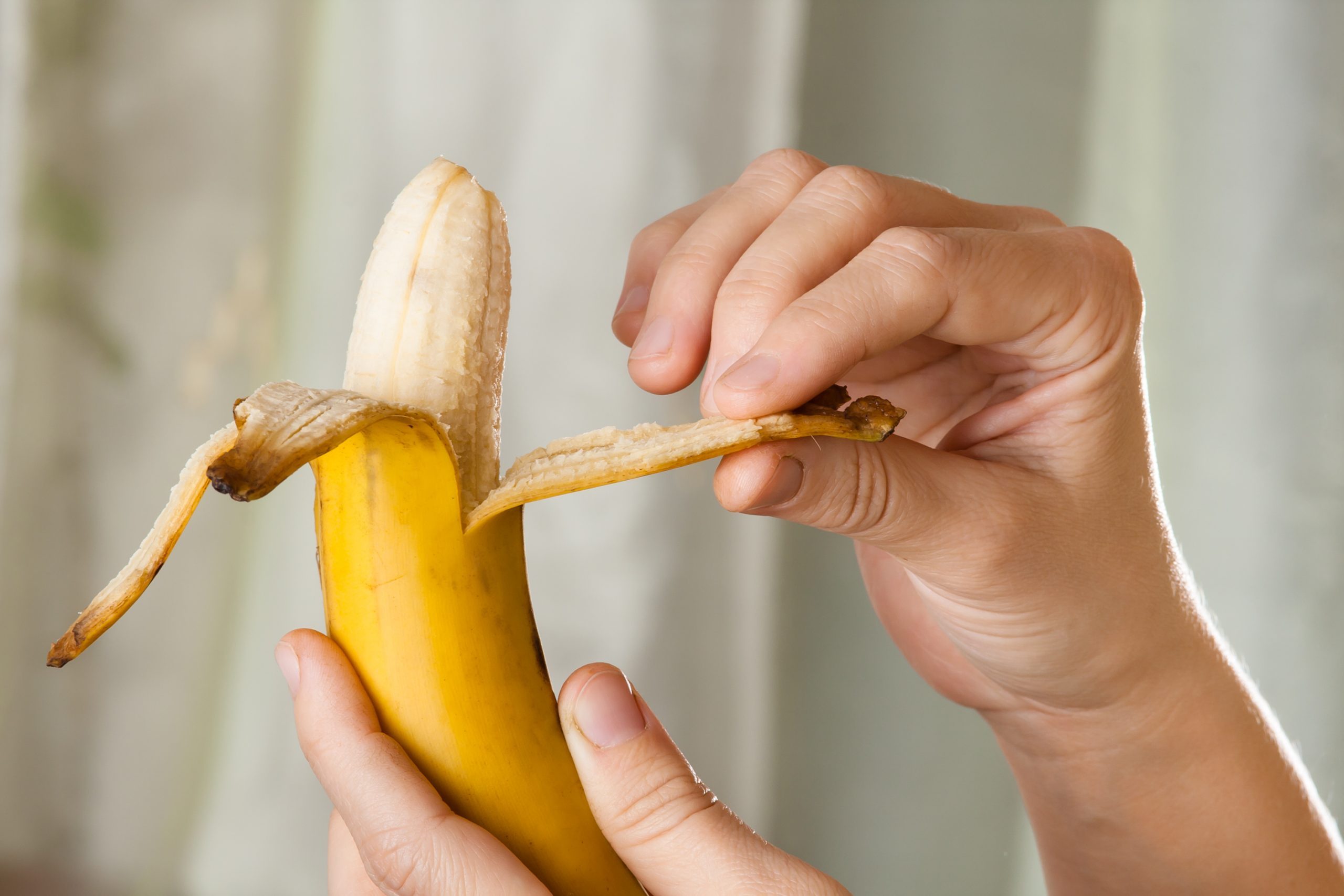 hands peeling a banana