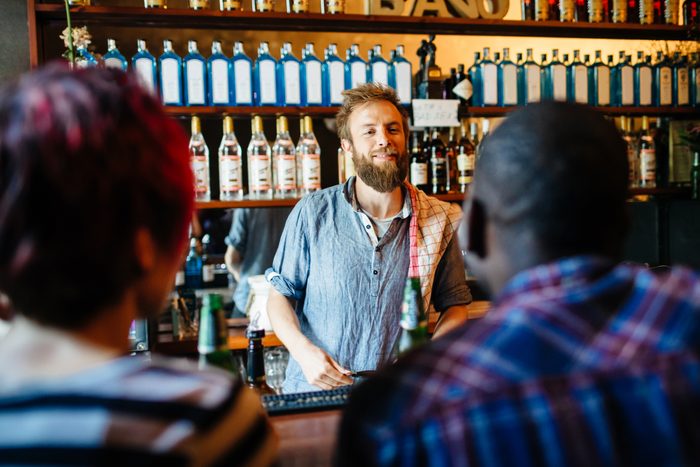 Young Hispter Bartender Talking With Customers