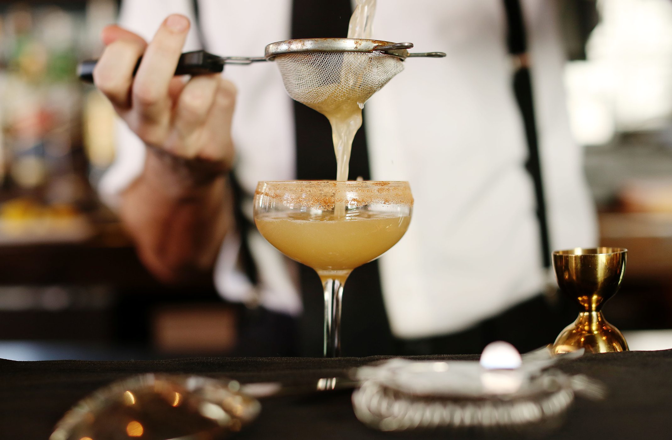 A cocktail being served at a bar