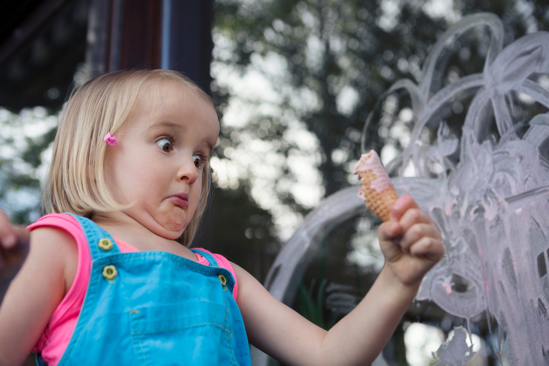 Girl (4-5) caught in the act, making a mess with ice cream