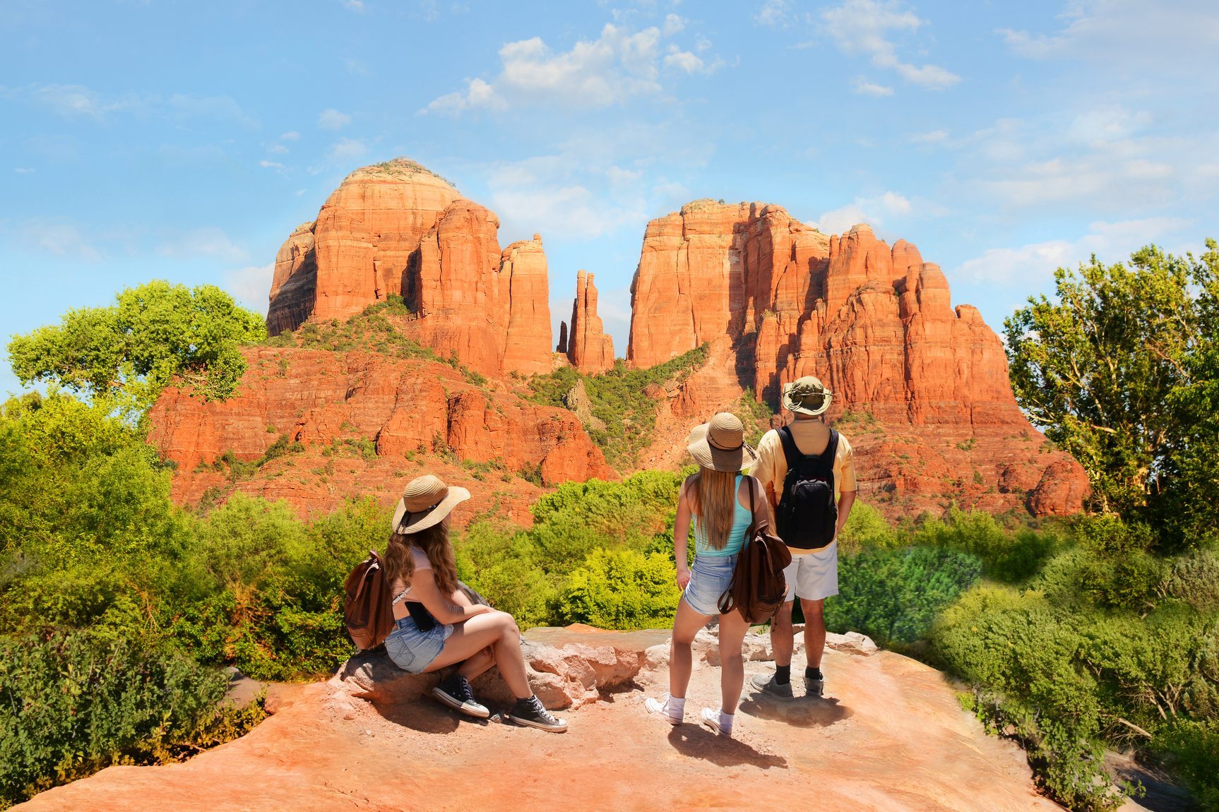 Family enjoying beautiful mountain view on summer hiking trip.