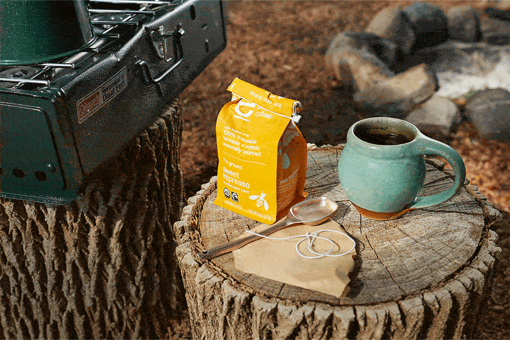GIF of coffee in a coffee filter bag being brewed on a tree stump