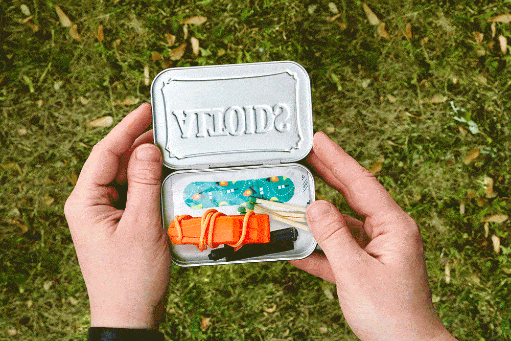 GIF of small essential items popping out of a metal mint tin