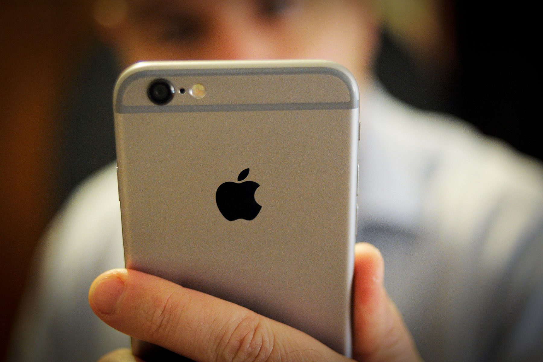 A man takes a photo with the front facing camera of an iPhone