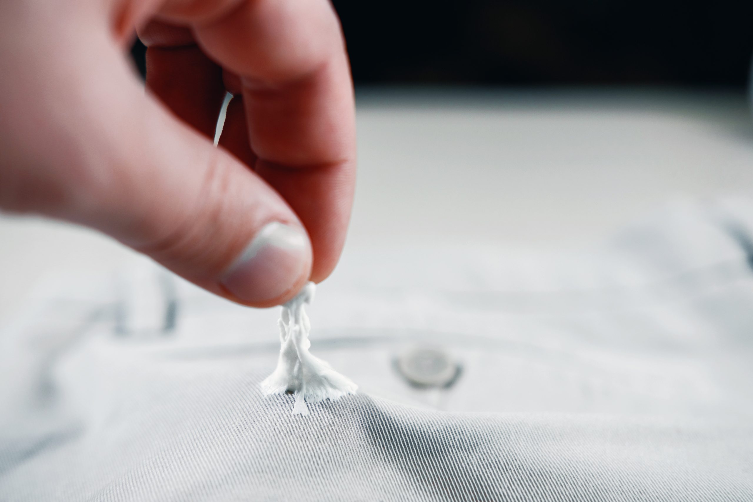 chewing gum stuck to the jeans closeup, removal of chewing gum from pants