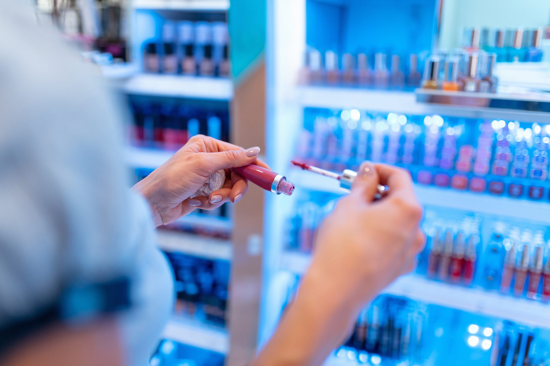 Looking for perfect shade of lip gloss at makeup stand