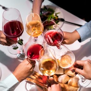 Cropped hands of executives toasting wineglasses