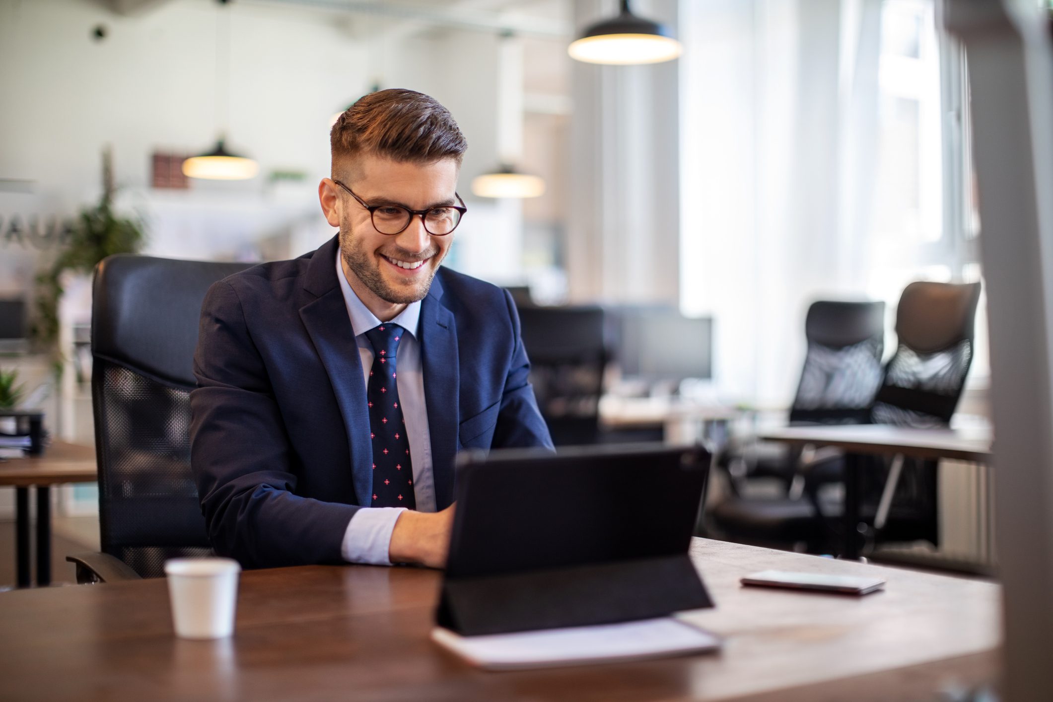 Businessman having online briefing with team at office