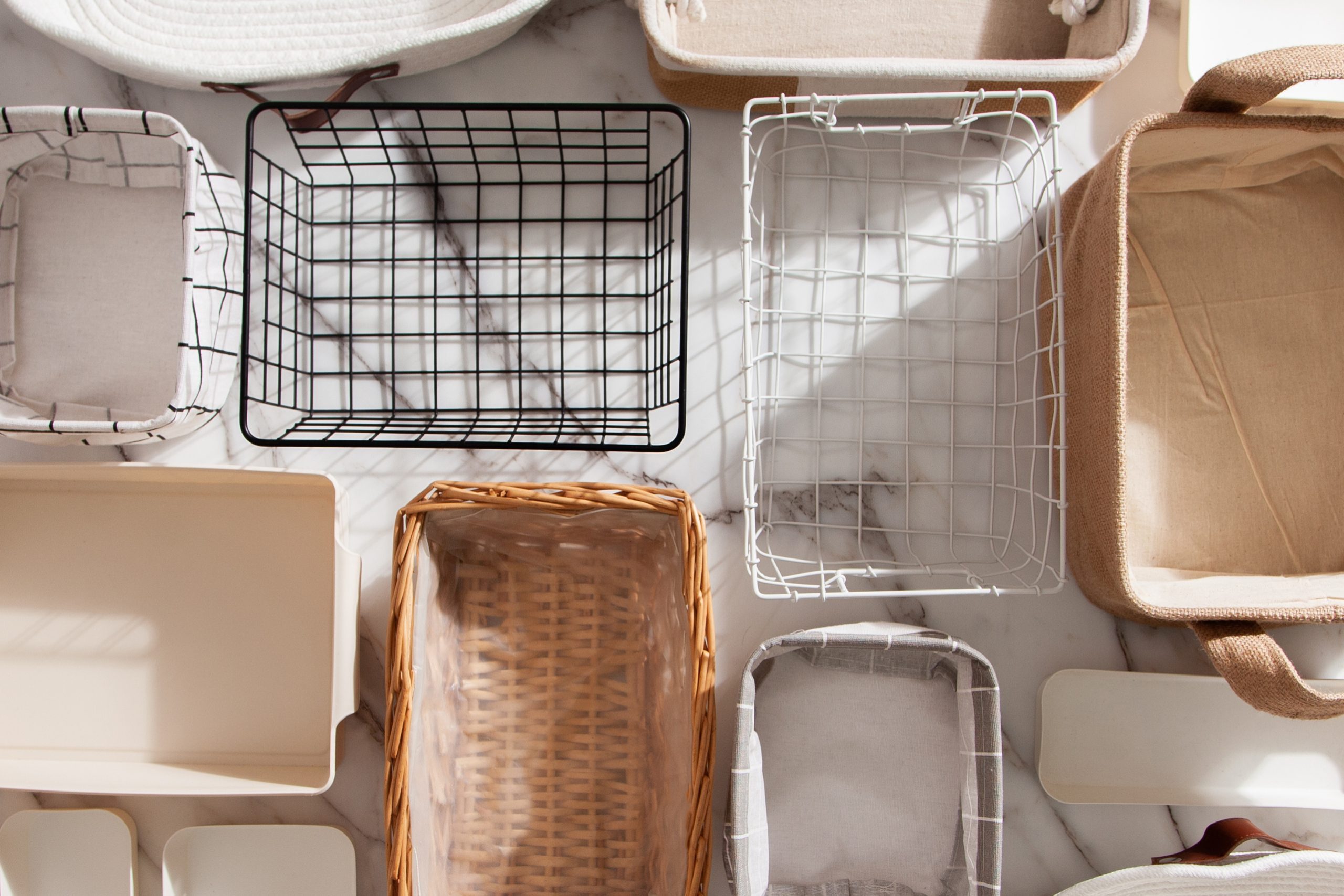 Flat lay of Marie Kondo's storage boxes, containers and baskets with different sizes and shapes