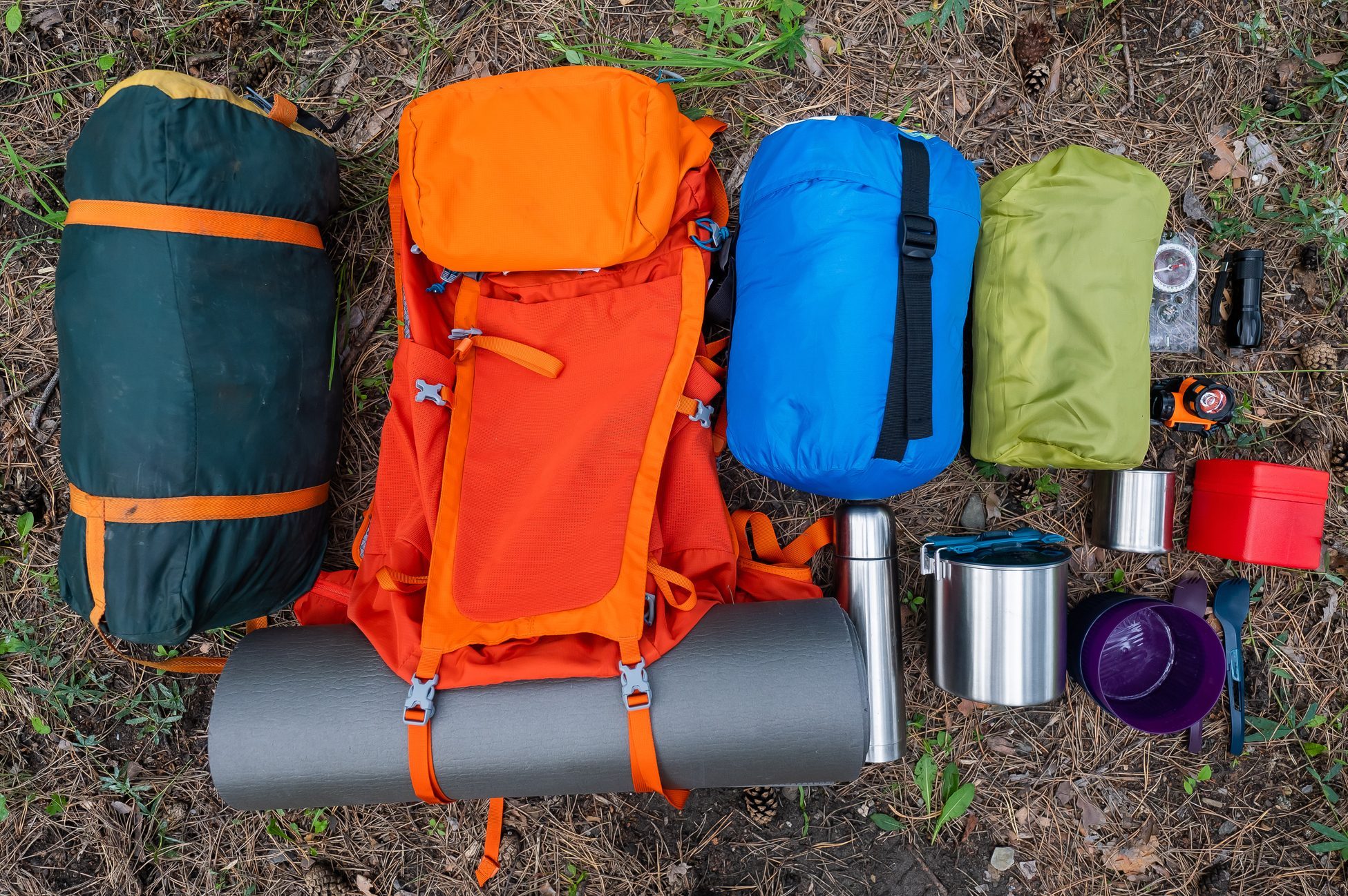 Hiking equipment. View from above. Pine forest