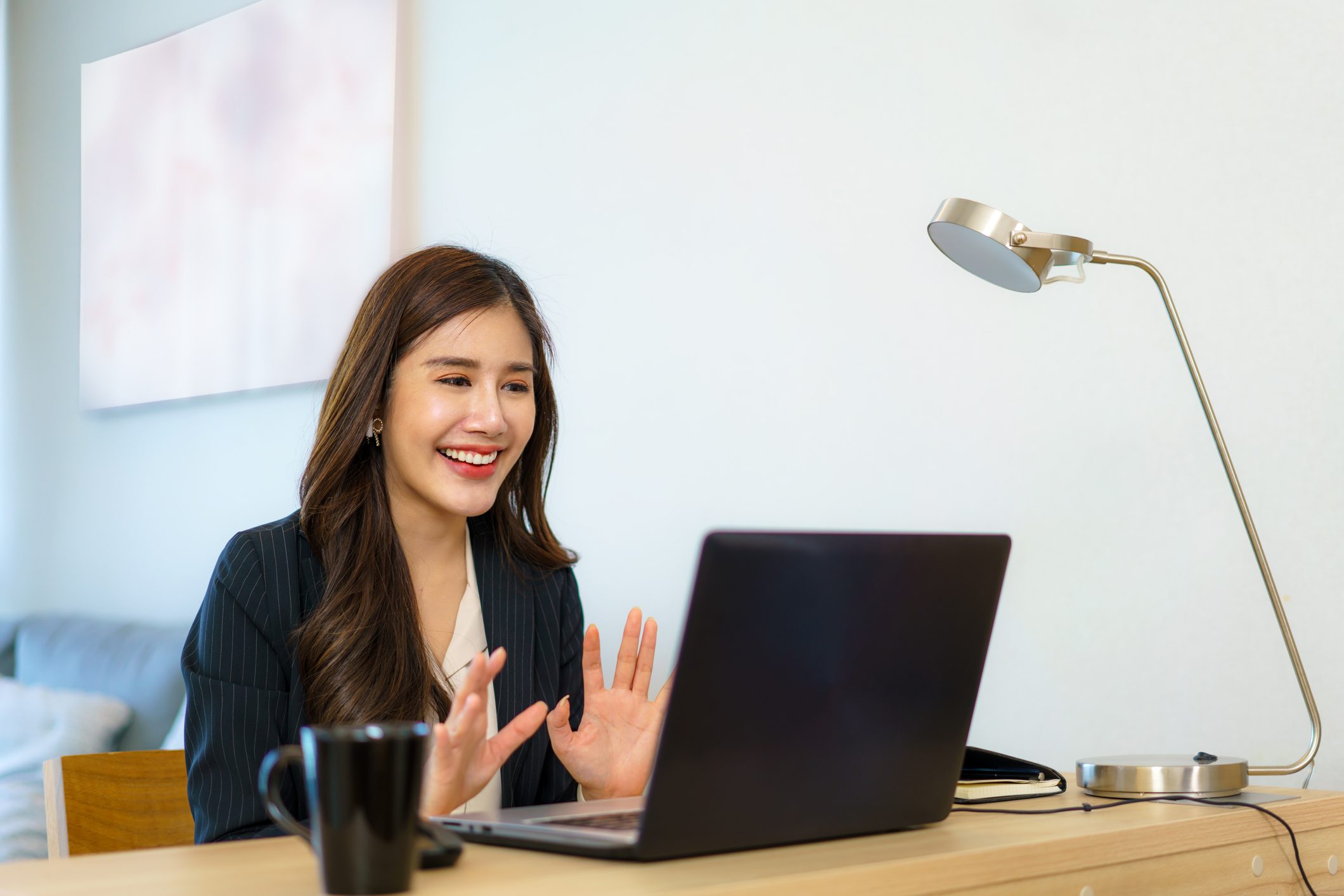 Asian business woman talking to her colleagues about plan in video conference. Multiethnic business team using computer for a online meeting in video call.