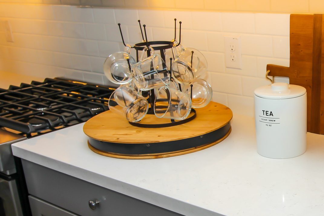 Kitchen Counter Top With Lazy Susan Of Glass Coffee Mugs