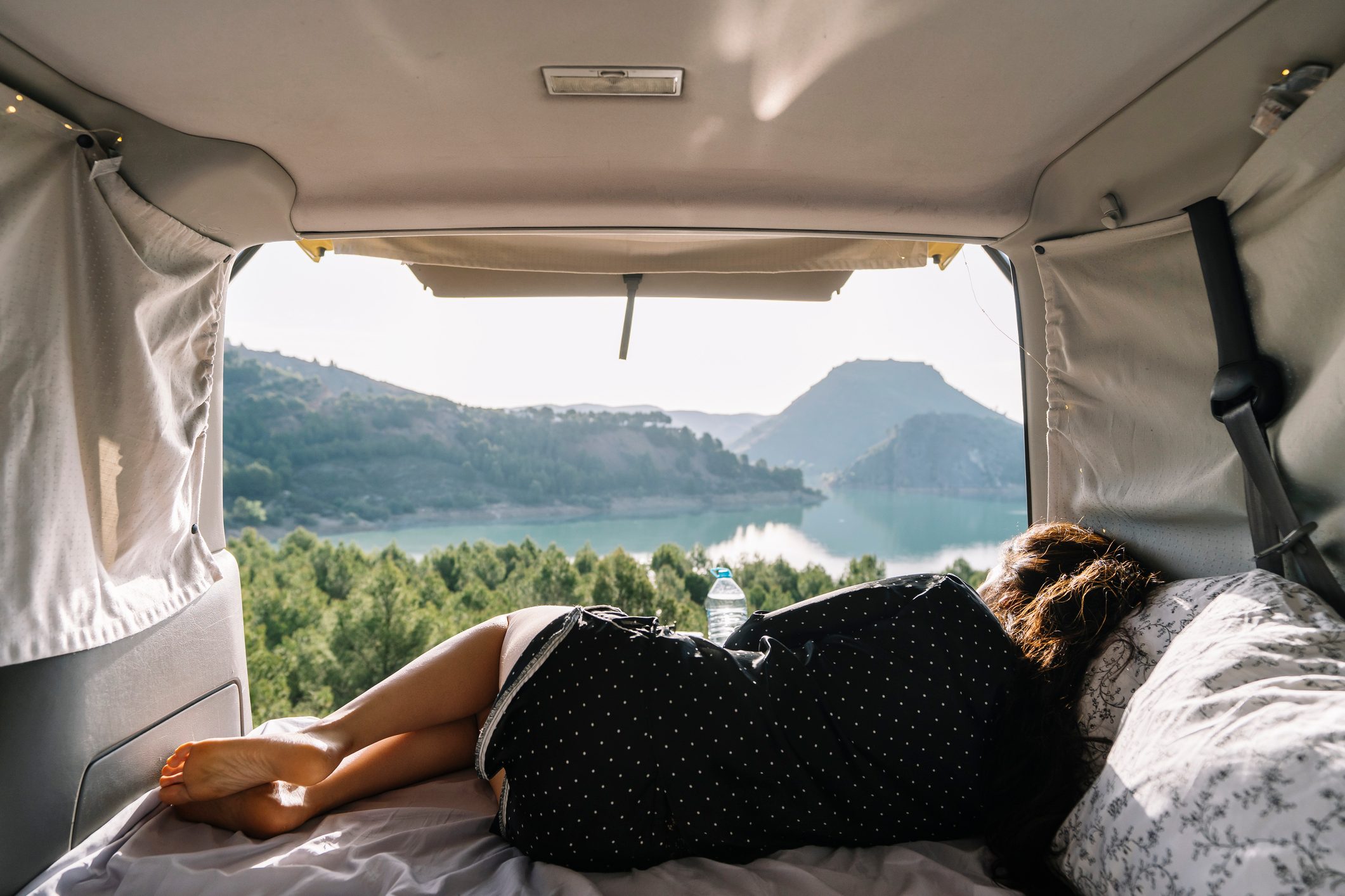 Woman relaxing in van on vacation