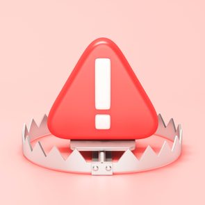 Red hazard warning attention sign on a metallic trap