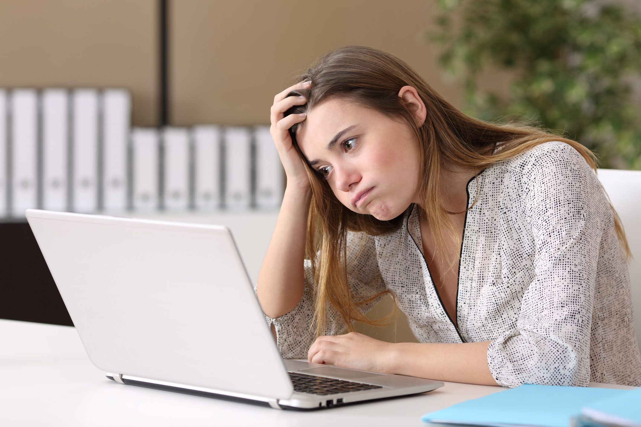 Frustrated intern working on line at office