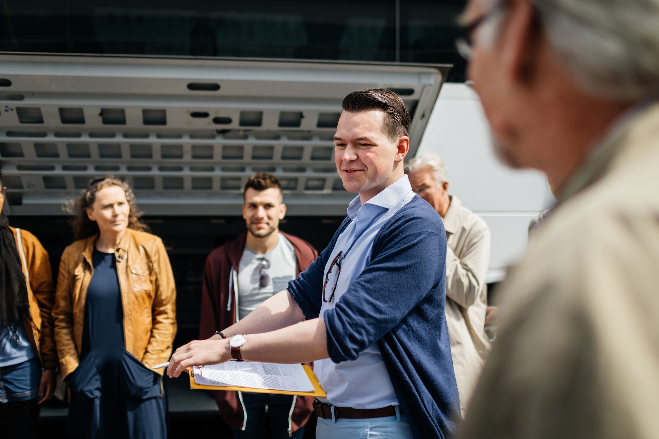 Travel Rep Discussing The Journey Details With Everyone Before Departure