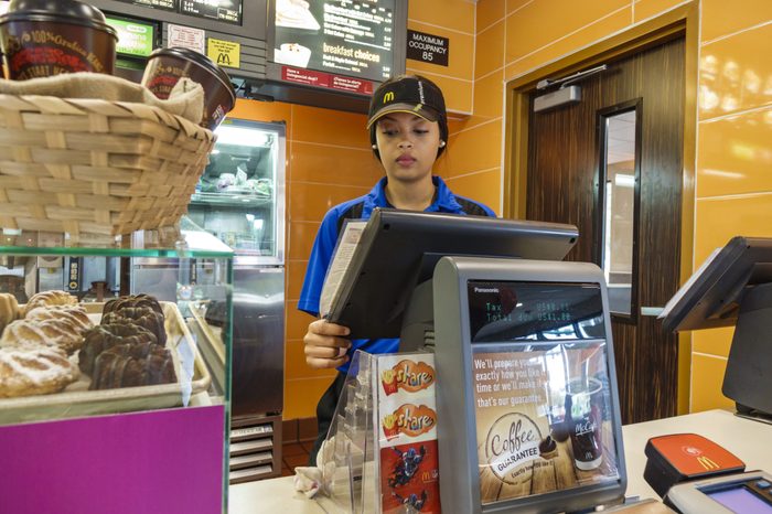 A woman employee at the counter in McDonald's.