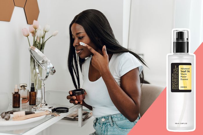 woman applying lotion to her face