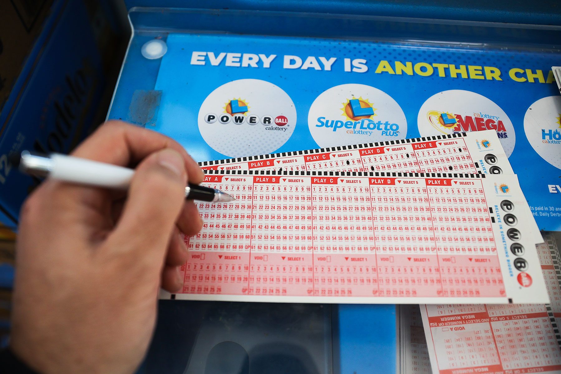 A person plays Powerball lottery at a 7-Eleven store in Milpitas, California