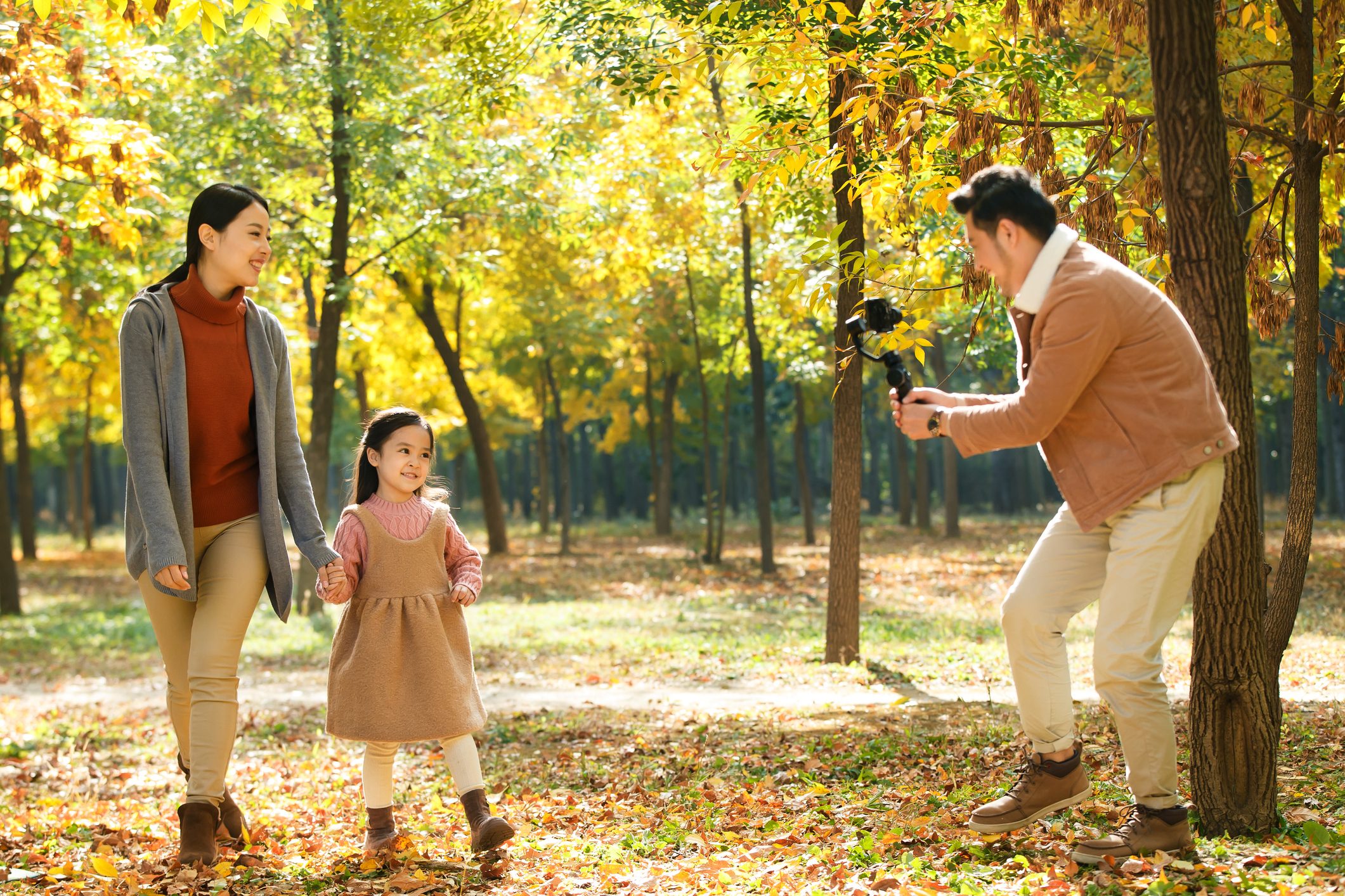 Happy family in the outdoor taking pictures