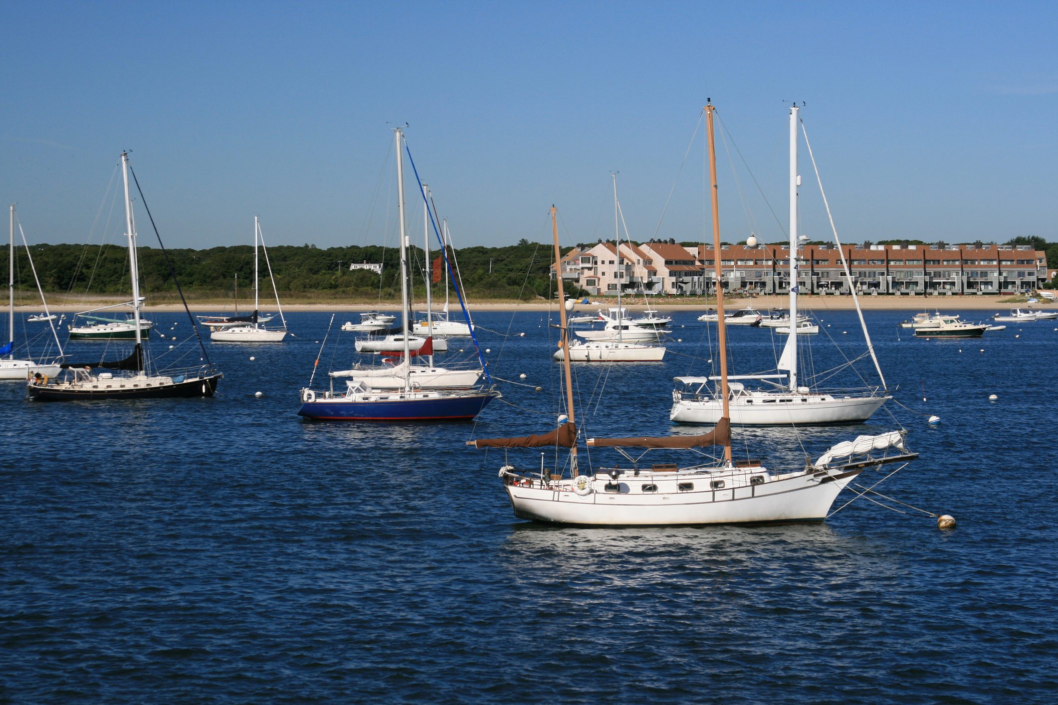 Sailboats moored at Hyannis Harbor, Cape Cod, Massachisetts. Blue sky.