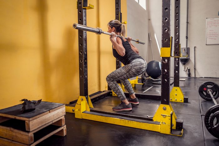 Young beautiful female working out in gym