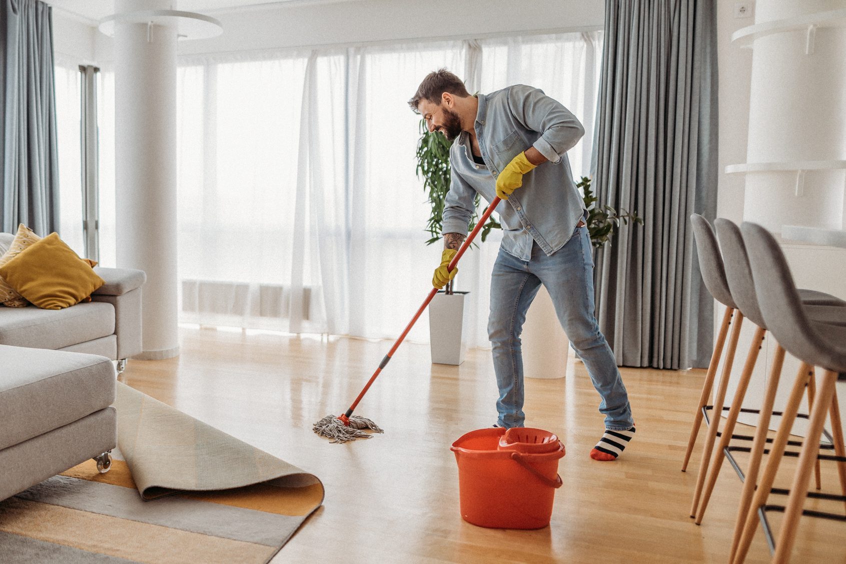 Young man cleaning his apartment