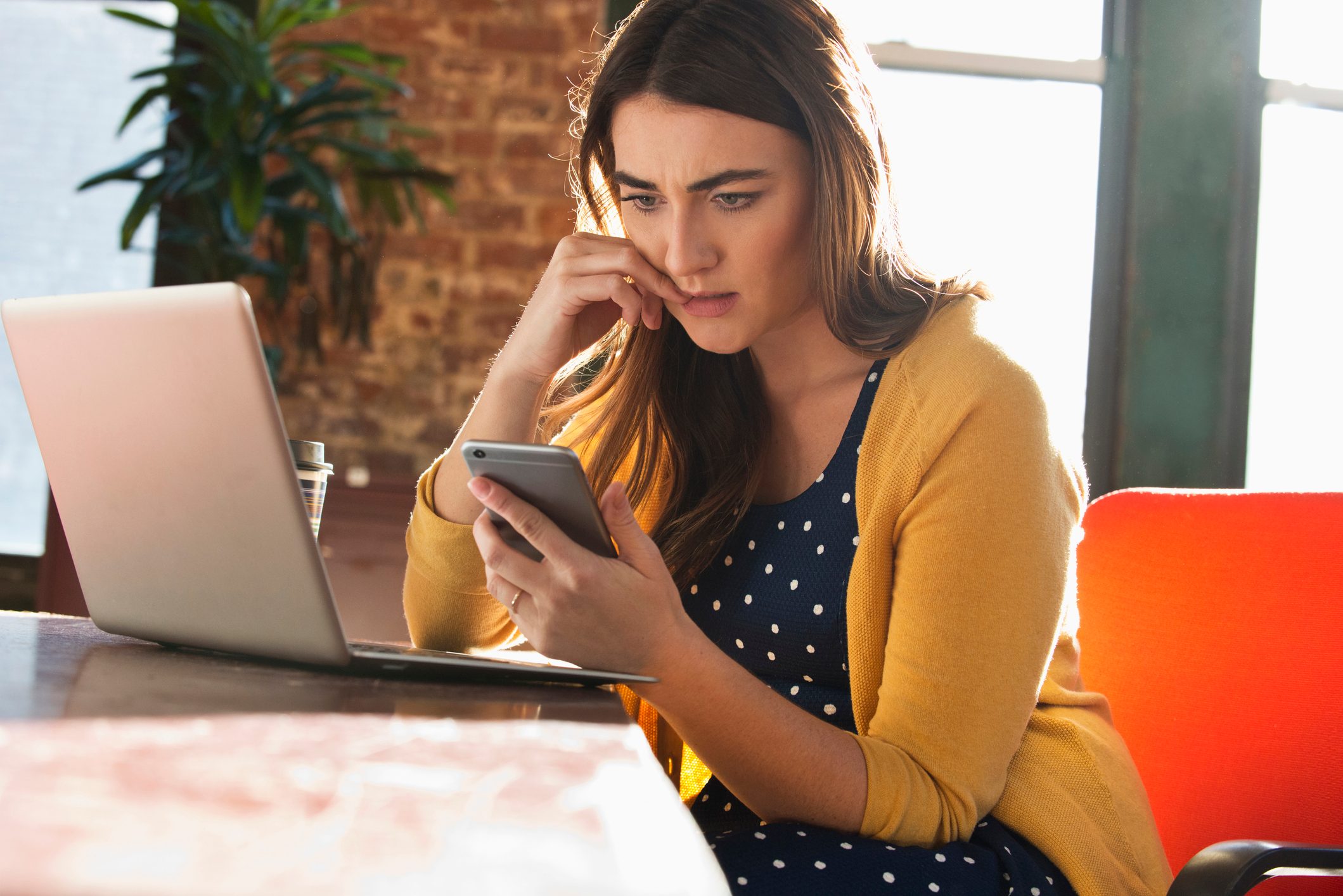 Stressed Caucasian businesswoman using cell phone