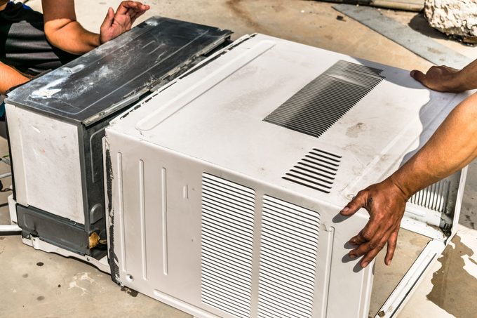 Dusty And Dirty Air Conditioning Cooling System Is Being Cleaning By A Professional Electrician Man