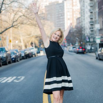 Ruth Rathblott in the streets with her hands in the air