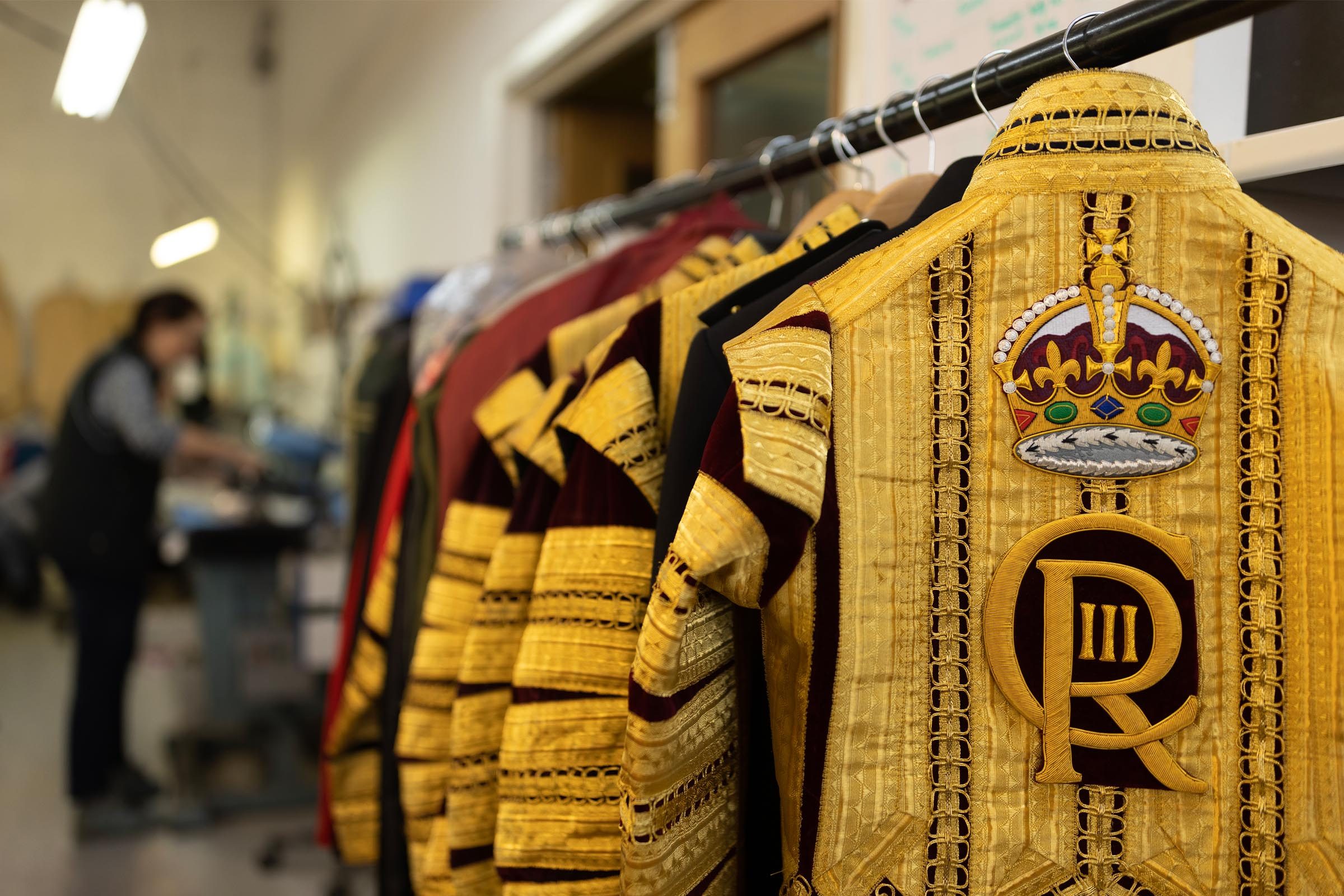 A State coat, to be worn by a Drum Major adorned with the new CR III cypher and Tudor Crown, also known as the Imperial Crown hangs on a rail at Kashket & Partners on April 19, 2023 in London, England.