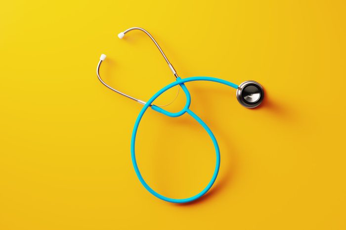 Blue Stethoscope On Yellow Background