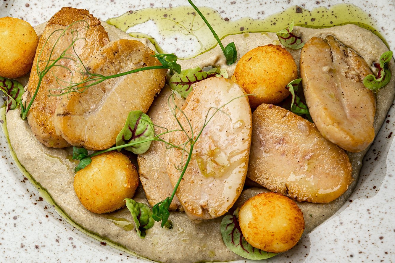 Fried bull testicles with potatoes and mushroom sauce.