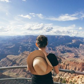 Woman looking over the Grand Canyon, one of the 7 natural wonders of the world