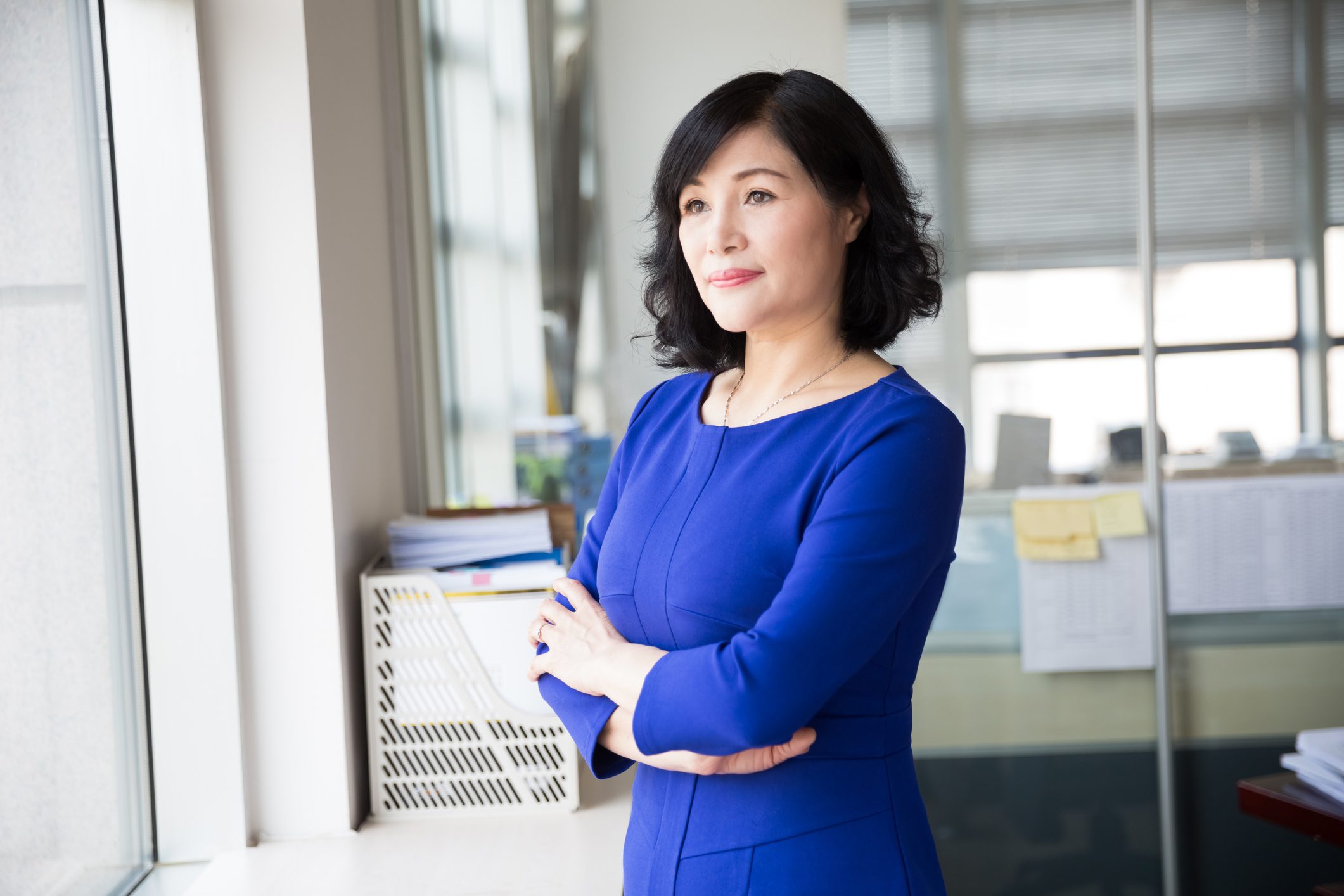 Middle Aged female wearing bold blue color dress