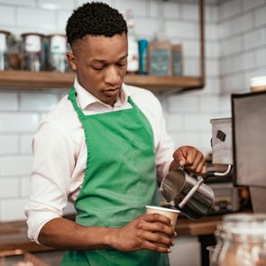 African bartender at work, making coffee