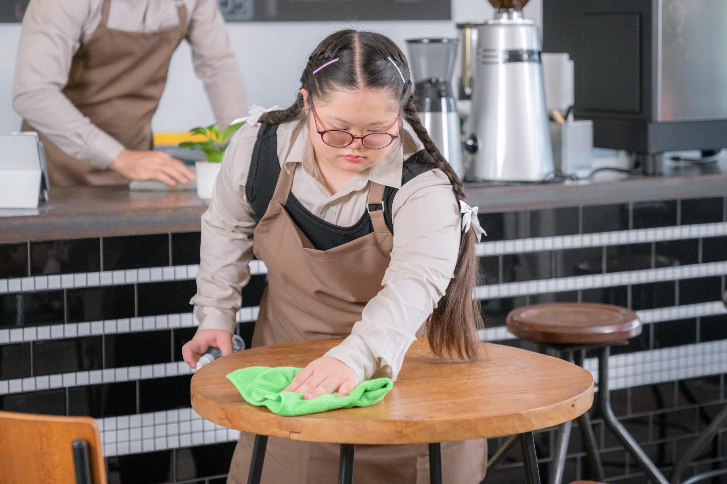 young Barista Cleaning a table