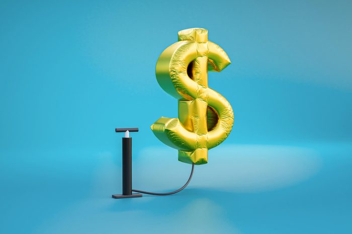 Inflation computer generated image of on a US dollar sign on a blue background