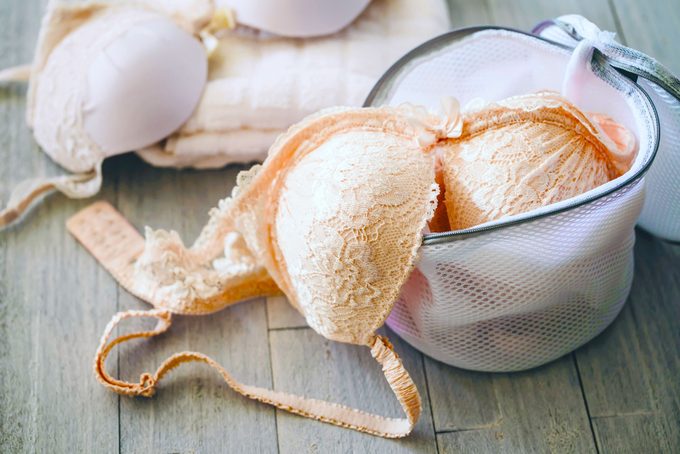 a bra in a an open mesh laundry bag for washing underwear in a washing machine