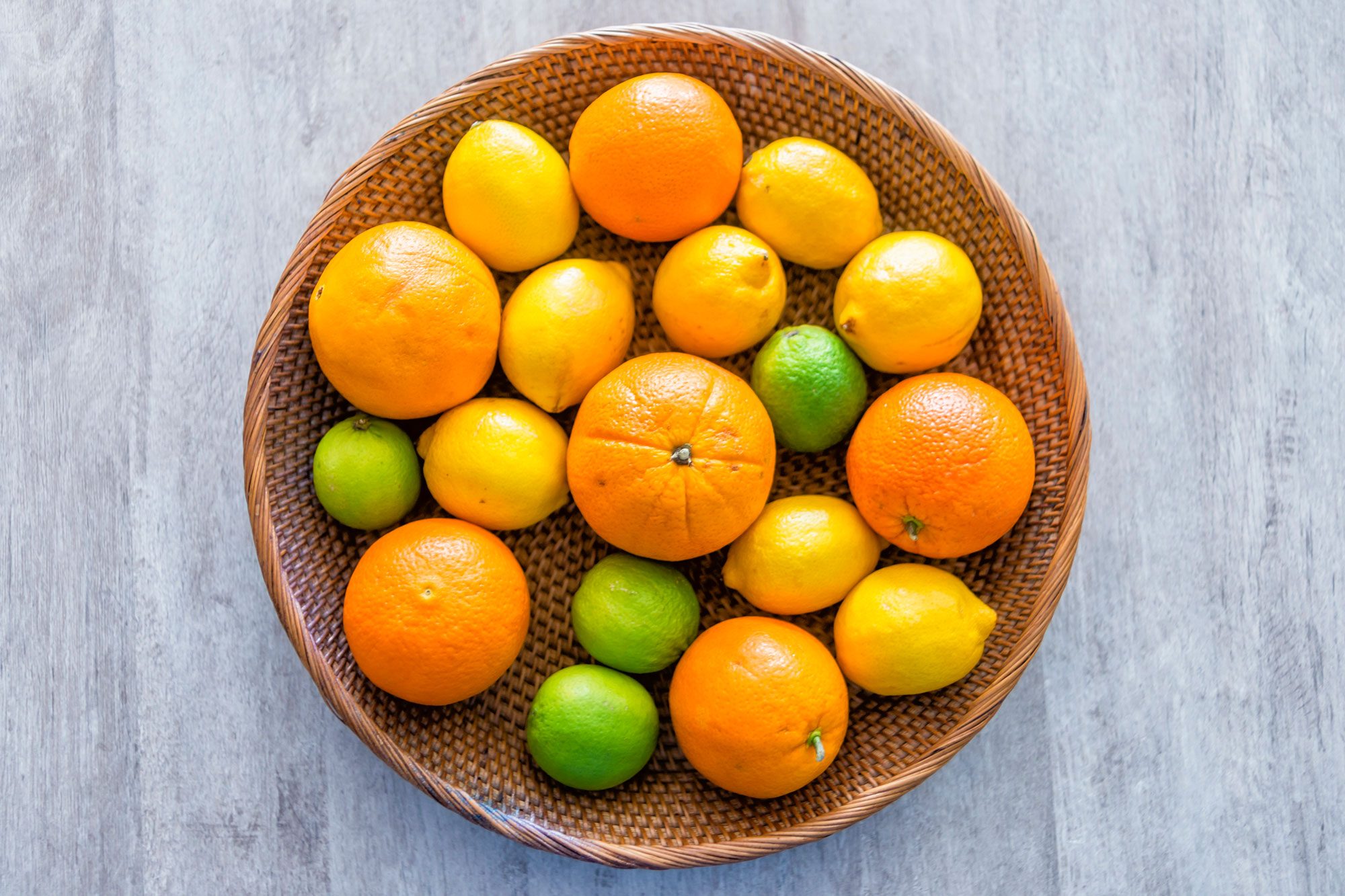 Citrus Fruits in a Basket, Above View Of Fruit Basket On A Table With Mandarins And A Melon