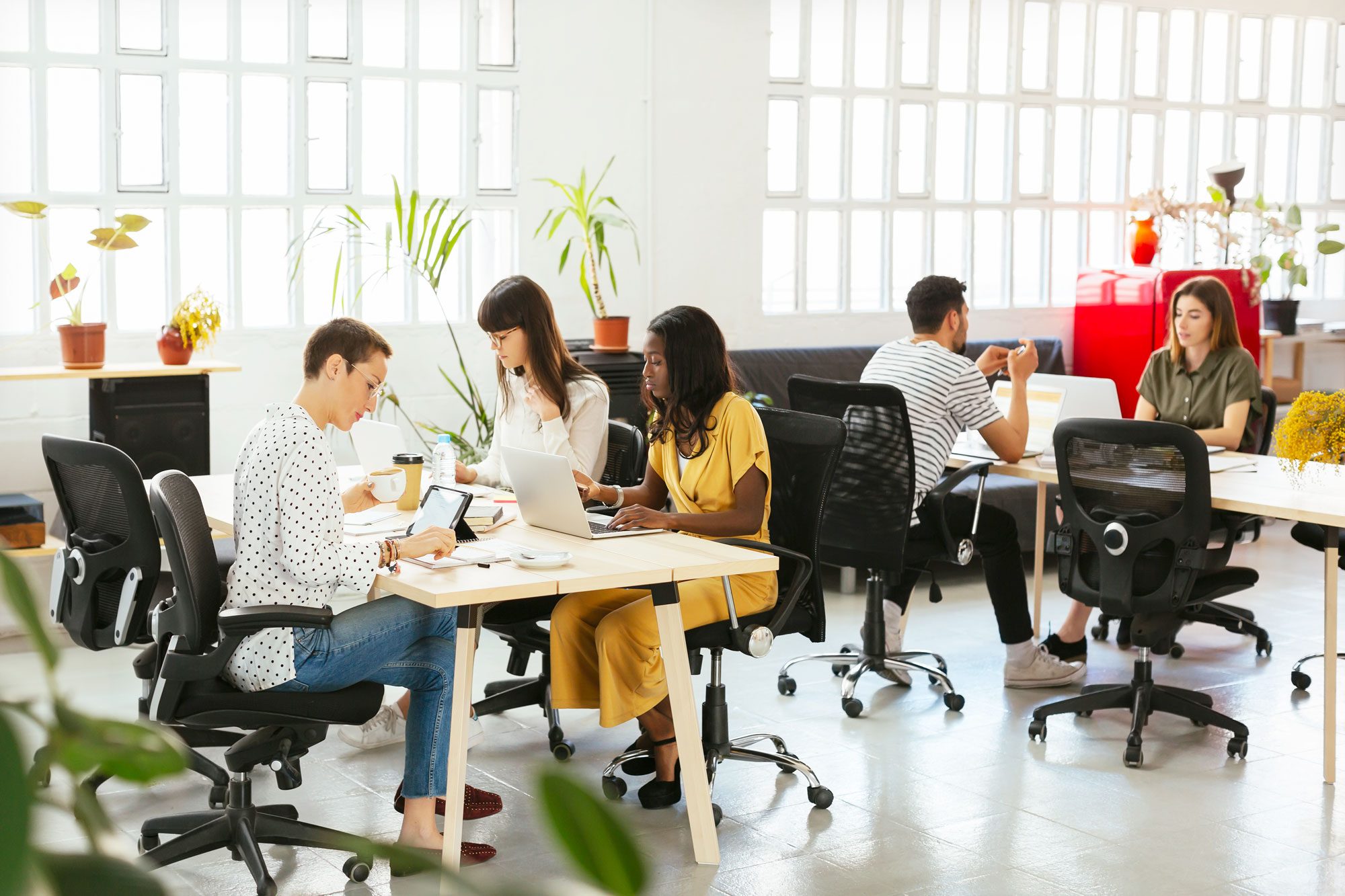 Colleagues Working At Desk In Office