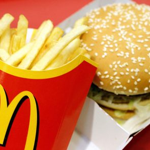 A Mcdonald's Big Mac And Fries Combo Meal Pictured on a Red Background