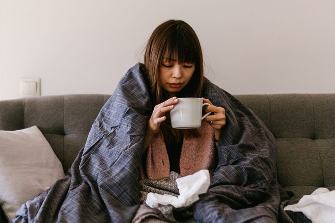 Asian woman sick at home