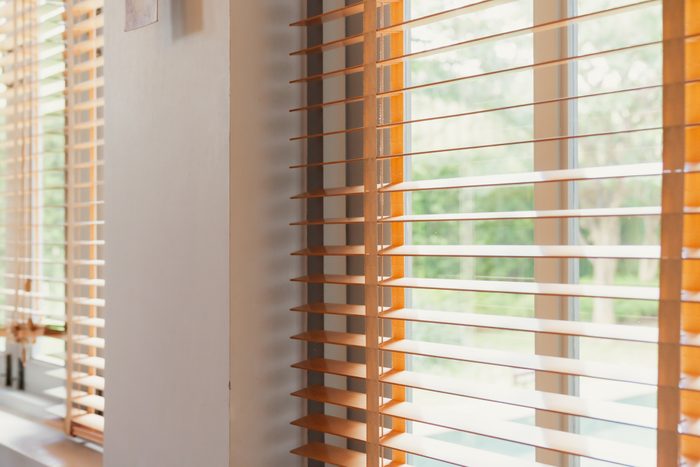 white window shutter blind with light from sun home interior concept