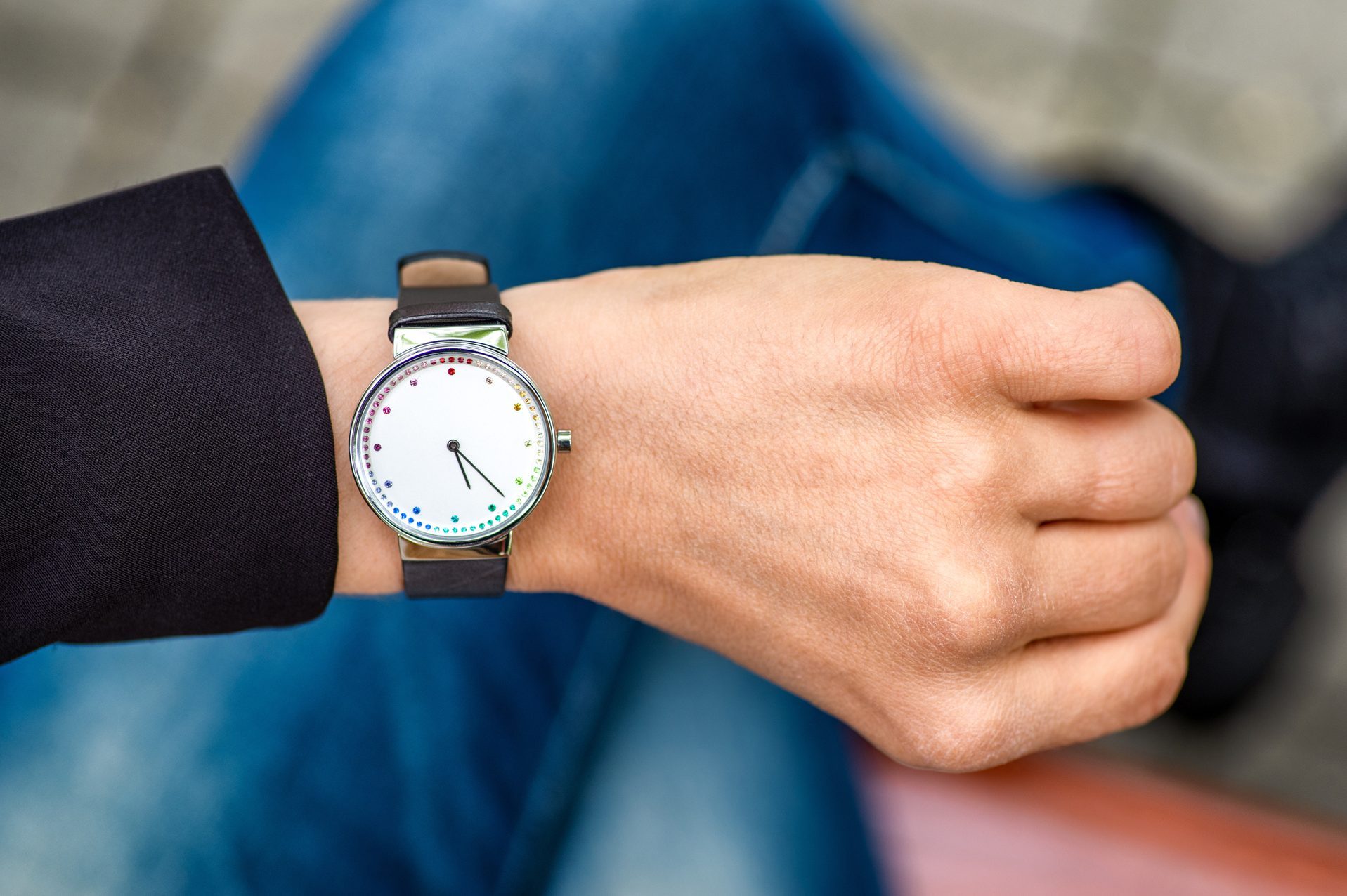 What time is it. Silver wristwatch on hand of woman.