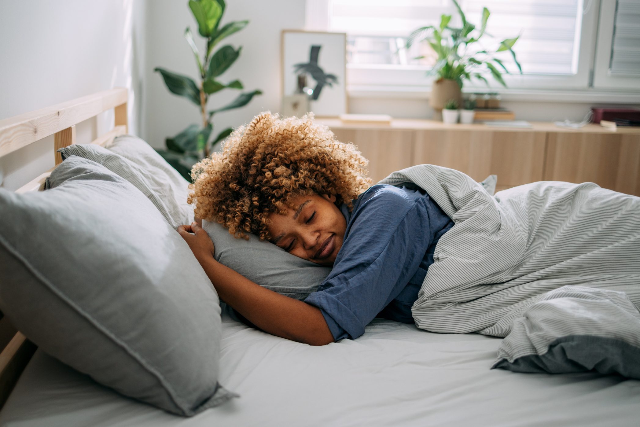 Beautiful Woman Sleeping in her Bedroom in the Morning