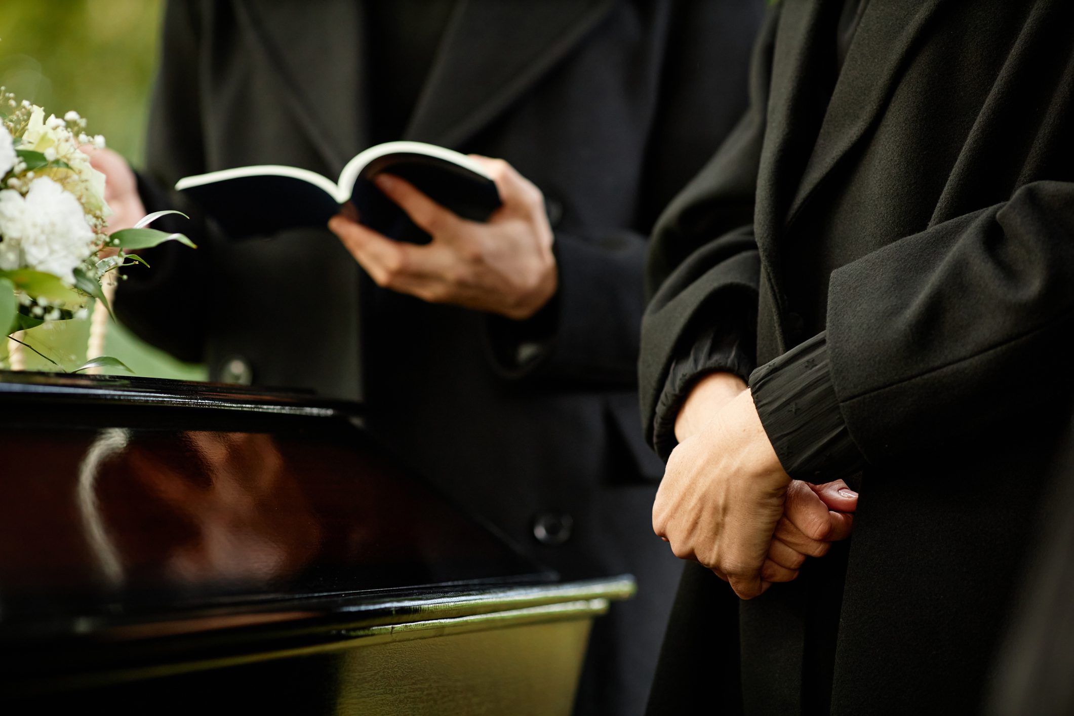 Close up of young woman standing by coffin