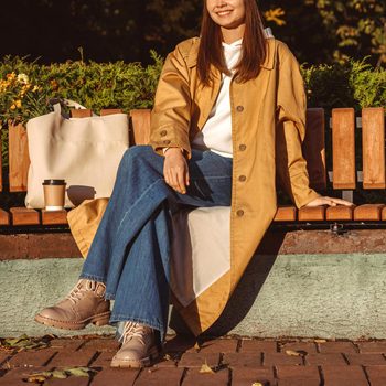 woman sitting on a park bench in autumn