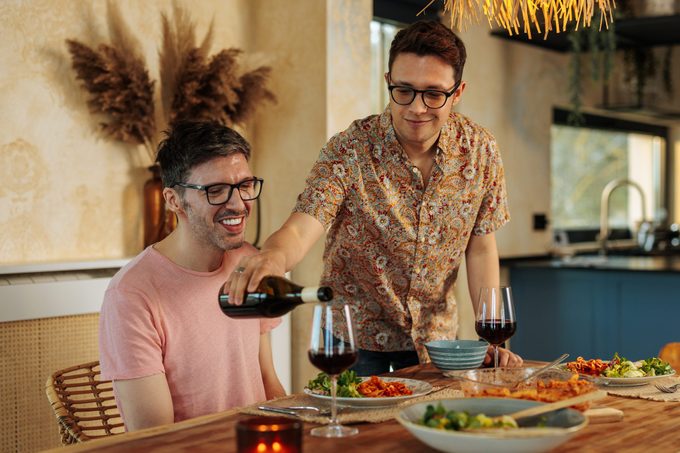 Cheerful gay couple bonding at lunch.